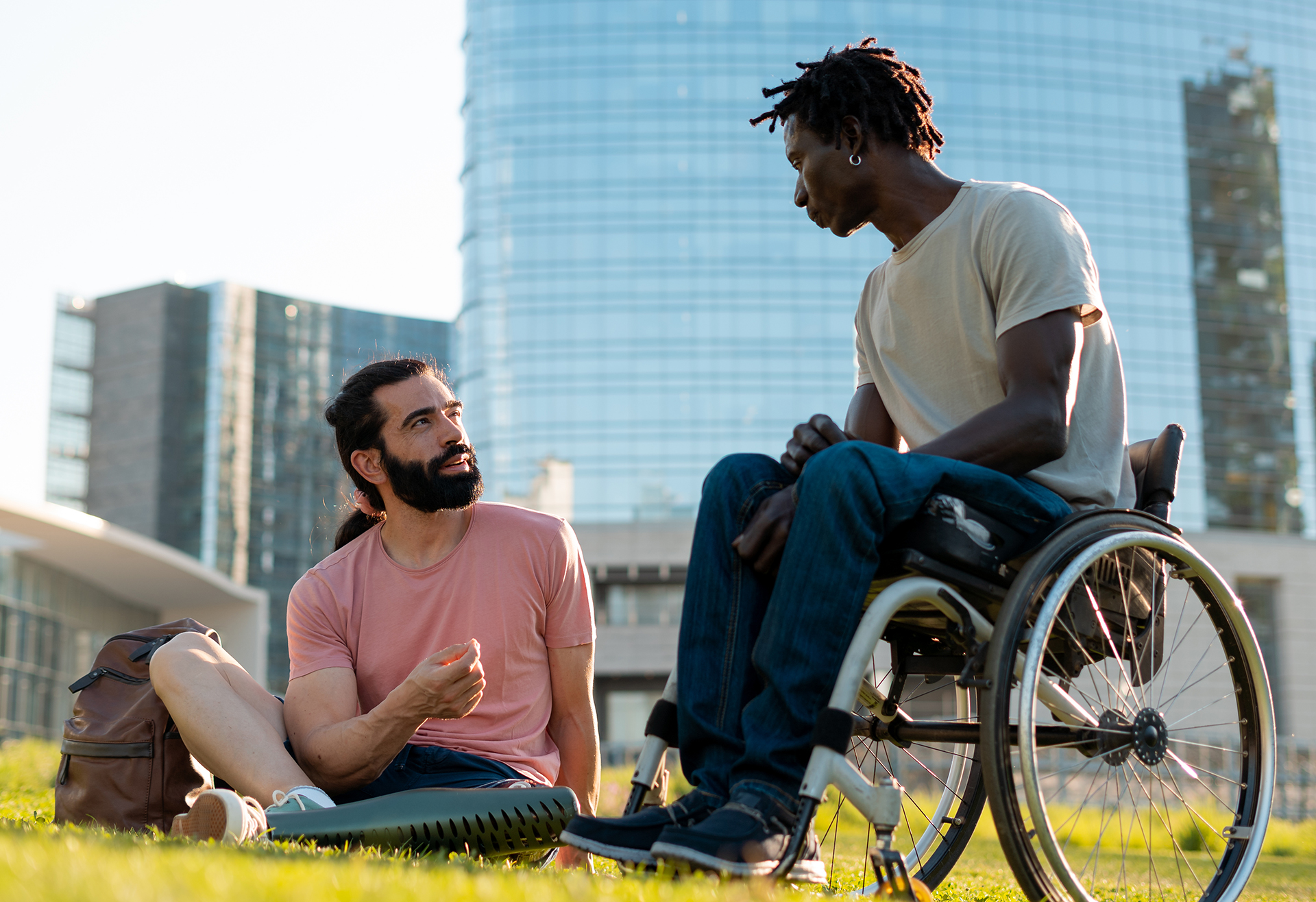 Two men with physical disabilities talking