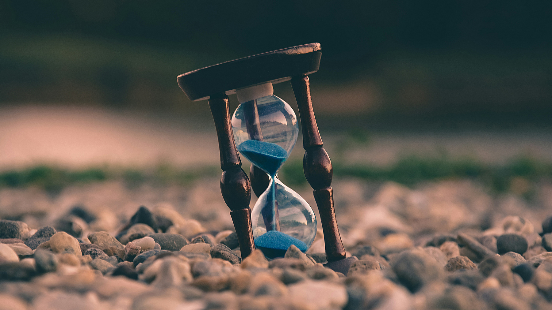 an hourglass on a rocky landscape