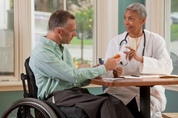 patient in wheelchair with doctor