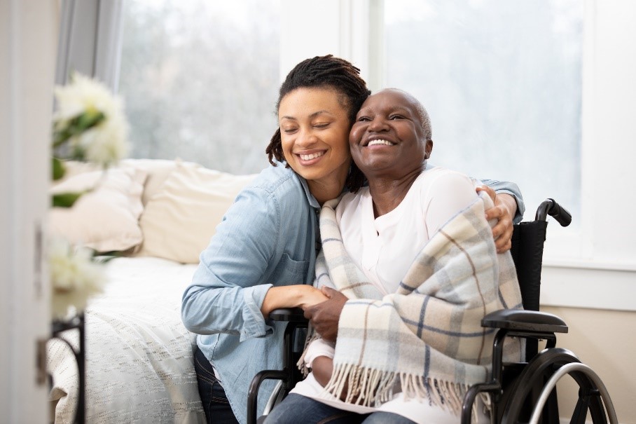 woman in wheelchair embracing