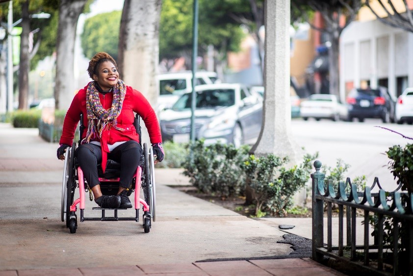 Woman in wheelchair in city